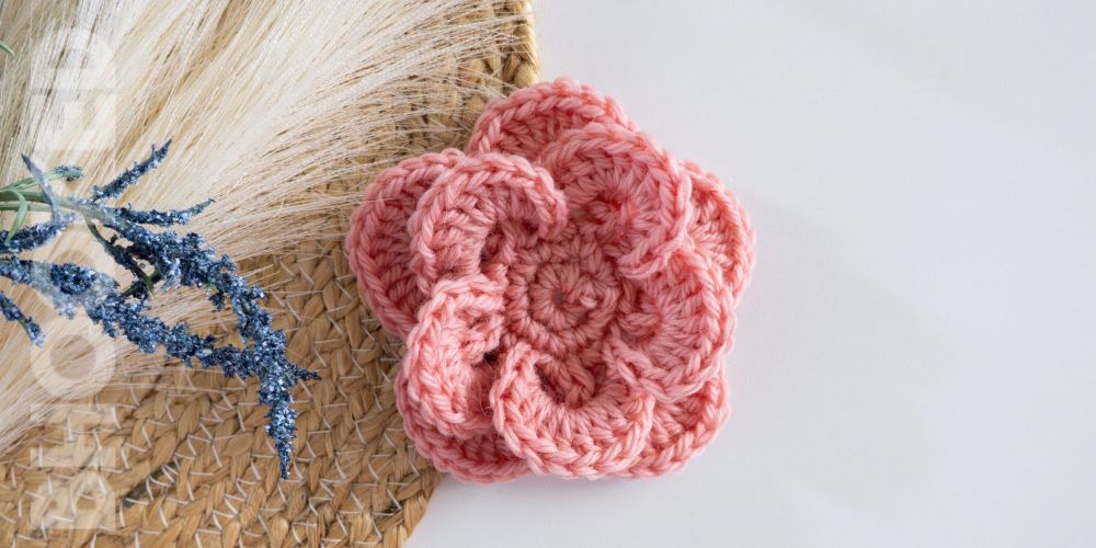 Pink colored realistic crochet flower