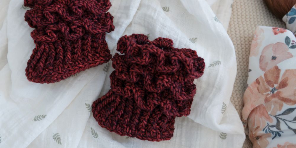 Dark red crochet baby booties with ruffles