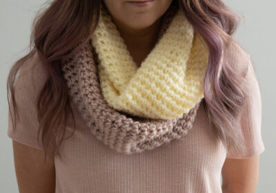 Pink and cream crochet infinity scarf worn with a light pink top.