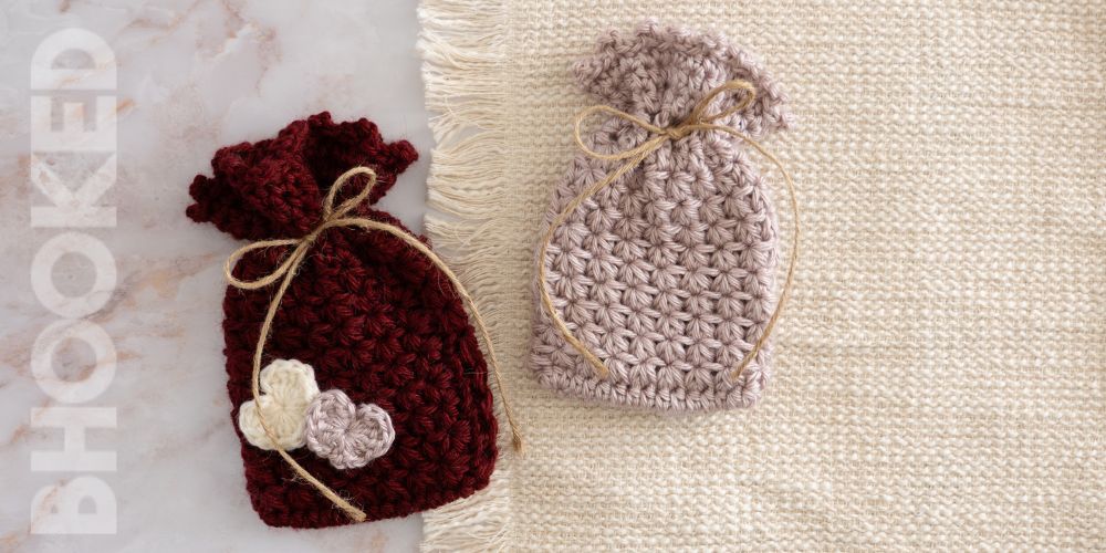 Pink and red crochet gift bag with hearts and twine.