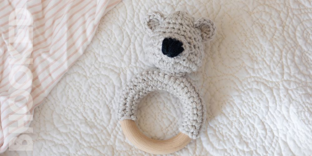 gray teddy bear crochet teether with pink blanket