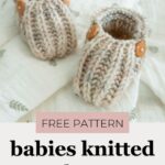 Cream knitted baby booties with orange buttons resting on soft patterned fabric, promoting a free pattern for babies' shoes.
